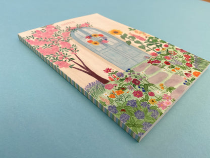 The spine with a stripy pattern of pale yellow, pastel blue and green colours.